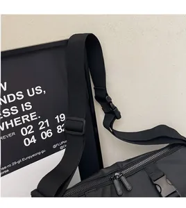 Detail showing smooth nylon texture with adjustable strap and dual zippers on black sports bag
