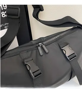 Detail of waterproof nylon crossbody bag featuring smooth double metal zippers and buckle