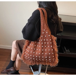 Caramel knitted tote bag featuring white pearl embellishments and soft feather fringe trim