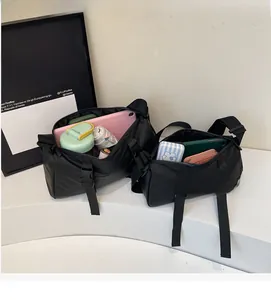 Detailed view of the spacious interior of this black nylon crossbody bag with daily items
