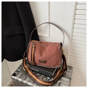 Detail of vintage brown shoulder bag with Serendipity JYUN label and striped wide strap