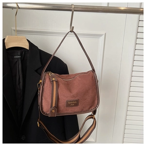 Detail of vintage square crossbody bag with adjustable wide strap and suede texture