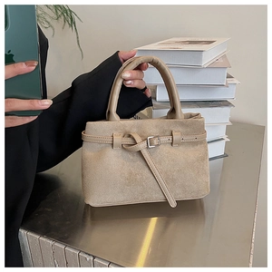 Detail of khaki frosted faux suede handbag featuring a retro silver metal buckle