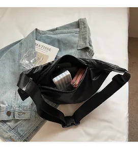 Internal view of black nylon crossbody bag showing large storage capacity for essentials
