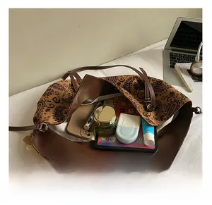 Internal view of large vintage tote bag showing spacious capacity for tablets and makeup