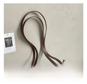Detail showing the brown paisley tote bag handle with high-quality metal buckle