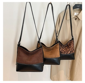 Variety of retro tote bags in solid brown and leopard print with black leather contrast