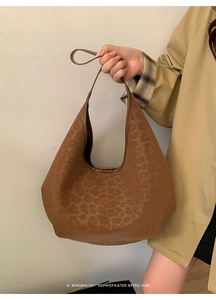 Close-up of a brown leopard print hobo bag showing minimalist retro texture and style
