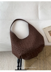 Close-up of retro leopard print hobo bag with a minimalist matte leather texture