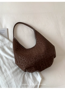 Close-up of dark brown leopard print tote bag with soft fabric and hobo style design