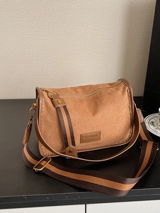 Brown faux suede underarm bag with vintage striped wide strap and top zipper detail