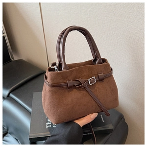 Detailed view of coffee suede leather tote bag with brown straps and metal buckle accent