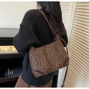 Detail of trendy leopard print shoulder bag with slim strap styled for autumn fashion