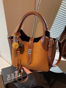 Retro brown leather bucket bag with suede patchwork and floral tassel charm