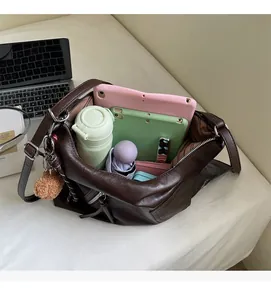 Detailed interior of deep brown faux leather tote bag showing large storage capacity