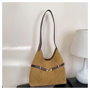 Close-up of vintage brown suede tote bag featuring deep brown leather straps and gold buckle