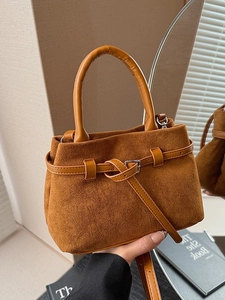 Vintage brown suede bucket bag with leather buckle detail and stylish top handle