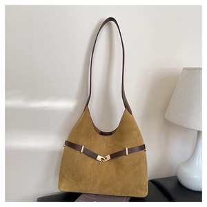 Detail of suede hobo bag with dark brown leather straps and golden metal hook closure