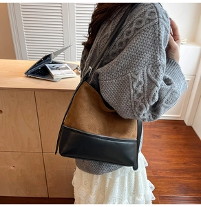 Detail of the dual-material patchwork tote bag with suede top and black leather bottom