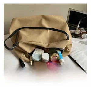 Detailed interior of a spacious khaki tote bag showing organized daily essentials