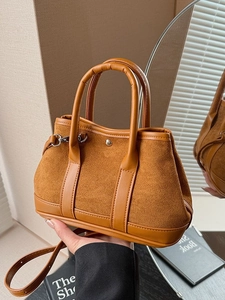 Vintage tan faux suede and leather bucket bag with top handles and adjustable strap