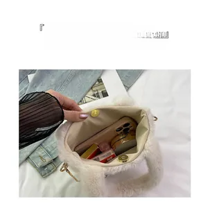Innenraum der weißen Plüschtasche mit goldenem Magnetverschluss und Platz für Utensilien