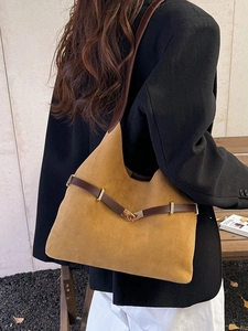 Retro mustard suede tote bag with brown leather trim and gold buckle worn by model