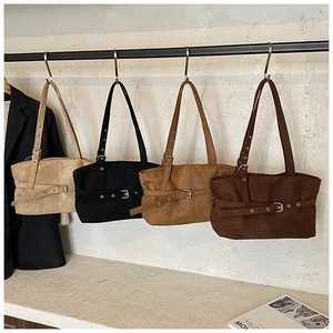 Four suede shoulder bags in beige black and brown colors with adjustable belt buckle detail