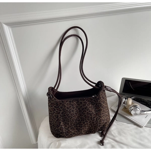 Detailed view of leopard print shoulder bag with suede texture and drawstring side details