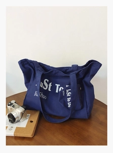 Detail of dark blue canvas tote bag set featuring large capacity and small zipper pouch