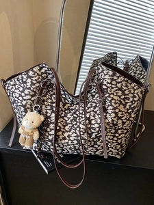 Retro leopard print tote bag with brown leather straps and cute plush bear accessory