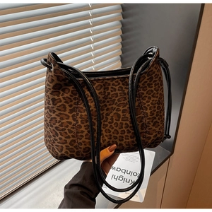 Close-up of leopard print shoulder bag featuring velvet texture and thin black straps