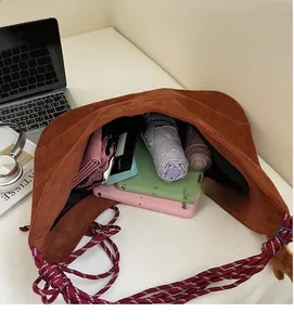 Interior view showing the large storage capacity of a brown suede hobo bag with accessories