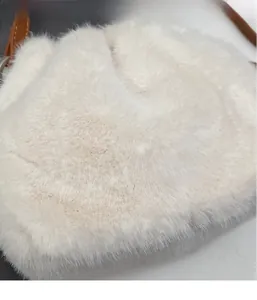 Close-up of fluffy white faux fur texture and brown leather strap on luxury bucket bag
