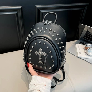Detail of black mini backpack with silver rivets and gothic cross pendant chain