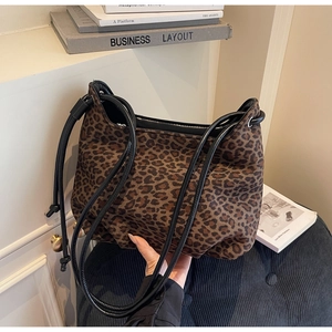 Close-up of leopard print tote bag with minimalist black double shoulder straps and soft texture