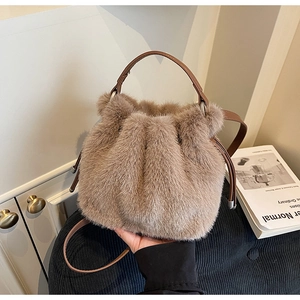 Close-up of soft brown faux fur bucket bag with leather drawstring and handle detail