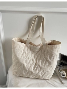 Large cream tote bag with S-letter quilting and shoulder straps for daily commuting