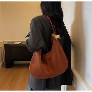 Brown suede hobo shoulder bag with red and white braided strap and cute dog charm pendant