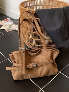 Brown suede tote bag with decorative metal buckle and adjustable shoulder strap