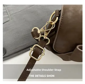 Close-up of adjustable shoulder strap with gold-tone buckle and durable metal clasp
