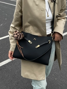 Vintage black faux leather tote bag with gold hardware and leopard print charm accessory