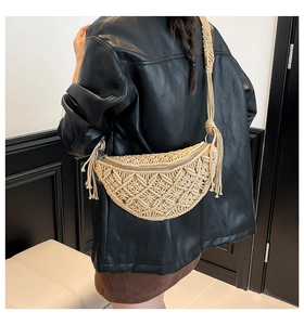 Detail of bohemian macrame crossbody bag with ivory fringe and woven texture