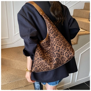 Close-up of vintage leopard print tote bag featuring premium suede texture and leather strap