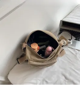Spacious interior of khaki nylon tote bag showing daily essentials and storage capacity