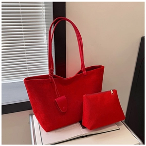 Macro detail of red suede tote bag set including matching small zippered pouch and charm