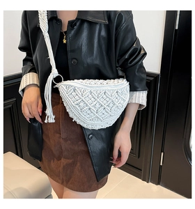 Close-up of white macrame crossbody bag with woven strap and fringe tassel details