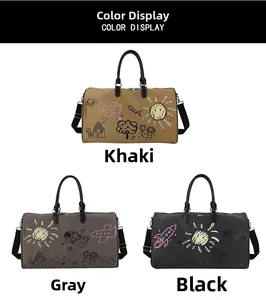 Detail view of graffiti canvas duffel bags in khaki, grey, and black with detachable straps