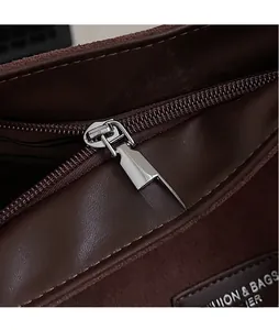 Detail of internal silver zipper and brand leather patch inside the dark brown tote bag