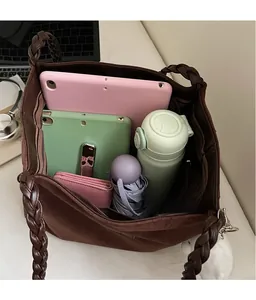 Large dark brown tote bag showing spacious interior for tablet, umbrella and water bottle
